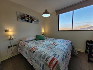 科皮亚波Atacama Valley 03的一间卧室设有一张床和一个大窗户