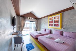 格兰岛Virawan pool kohlarn วิราวัน พลู รีสอร์ต ที่พักเกาะล้าน的配有粉红色床单的客房内的两张床