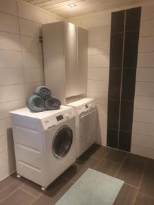 波多Idyllisk sjøhus på Naurstad的小房间里的洗衣机和烘干机
