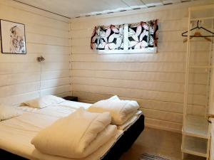 SaxnäsKultsjögården-Saxnäs- Marsfjäll 10的一间卧室配有一张带白色床单的床和一扇窗户。