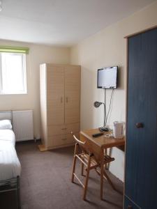 伦敦帕丁顿公寓的酒店客房设有一张桌子、一张床和一间卧室。
