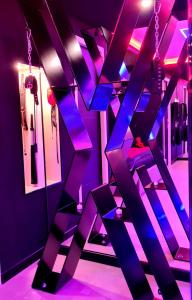 里沃萨尔特LES SECRETS ROOMS, LOVE ROOM DE LUXE AVEC JACUZZI的一间设有紫色客房和梯子的房间