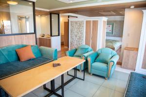 斜里町知床第一酒店的客厅配有2把蓝色椅子和桌子