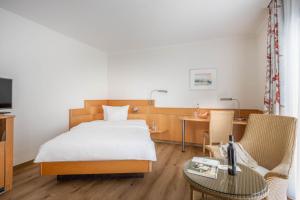 腓特烈港科隆环形酒店的酒店客房带一张床、一张桌子和椅子
