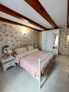 格罗日年Apartment Bellavista的一间卧室配有一张带粉红色床罩的床