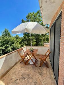 Barbarano RomanoCasale Campecora的庭院内桌椅和遮阳伞