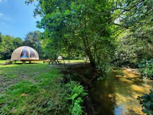 米奥La Wigwam Bleu du Domaine du Pas de l'âne的河旁有帐篷的田野