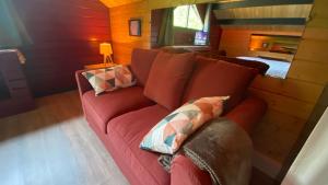 博尼约Domaine Vallon des Ocres的客厅配有红色沙发及枕头