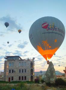 格雷梅Ala Stone Hotel的一组热气球飞越一座建筑物