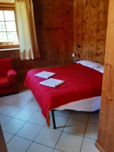 利维尼奥Appartamenti Joseff的一间卧室配有一张带红色毯子的床