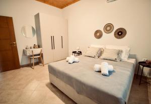 尼亚·卡利克拉提亚Enalio Beach House的一间卧室配有一张大床和毛巾