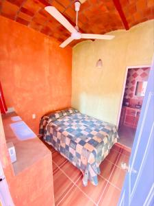瓜亚比托斯Bungalows El Rincon de La Riviera的一间卧室配有一张床和吊扇