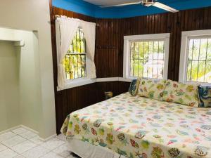 西区马里波萨山林小屋的一间卧室设有一张床和两个窗户。