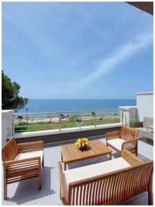 乌马格Villa Lucia Umag的一个带桌椅的庭院和海滩