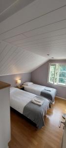 科科拉The Grey House的一间卧室设有两张床和两个窗户。