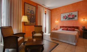 波凯兰特L'安国拉酒店的酒店客房带一张床、一张桌子和椅子