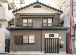 东京Japanese traditional house.Ryokan in asakusa with 2bedrooms的灰色的房子,有 ⁇ 帽屋顶
