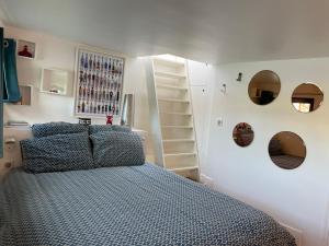 巴黎Péniche "SunFlower"的卧室配有一张床,墙上设有镜子