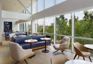 亚特兰大Omni Atlanta Hotel at Centennial Park的大堂设有蓝色的沙发、桌子和窗户。
