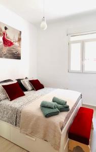 瓦伦西亚Apartamento Valencia Turia San Pio V的白色卧室配有一张带红色枕头的大床