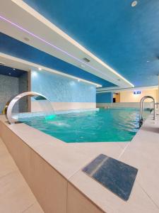 兹拉蒂博尔Goldview Apartmani的蓝色水中的酒店的游泳池