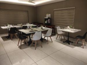 AttingalSoorya的一间设有白色桌椅的用餐室