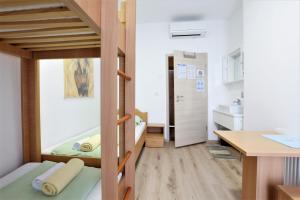 波尔托罗Hostel Soline的小房间设有双层床和书桌