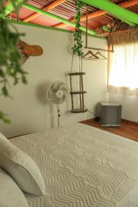 RizaraldaRoom in Lodge - Glamping Cabin的卧室配有白色的床和风扇