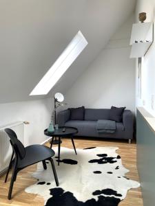布雷根茨Bright + Cozy Dachgeschoß Maisonette im Zentrum的客厅配有沙发和桌子