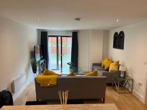 利兹Lovely 2 Bed apartment in Leeds centre (Netflix)的带沙发和黄色枕头的客厅