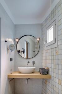 波西多尼亚Calma Boutique Hotel的一间带水槽和镜子的浴室