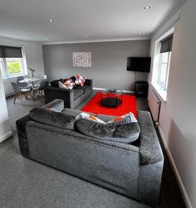 伦弗鲁Renfrew Home from Home的客厅配有两张沙发和红色地毯