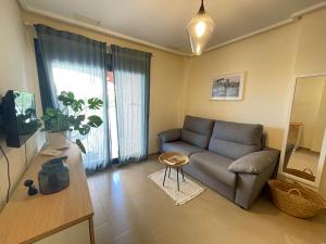 德尼亚Apartment Jardines y Mar的客厅配有沙发和桌子