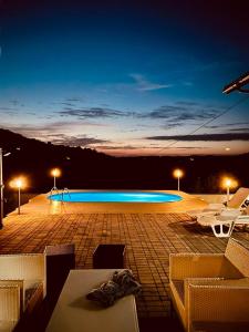 图兹拉Lexor Holiday Home的夜间游泳池,灯光照亮