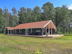 莱斯Holiday home Læsø LIII的一座小房子,在田野上设有大甲板