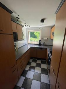 蒂宾根2-Zimmer-Nichtraucher-Ferienwohnung Strobel的厨房配有木制橱柜和窗户。