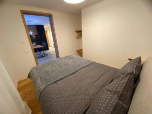 马洛亚Flat Cervo holiday for winter-sommer sports的一间卧室配有一张带枕头和桌子的床