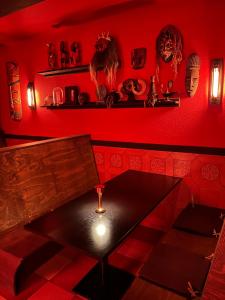贝尔加Insomnia Hotel的红色的房间,设有桌子和红色的墙壁