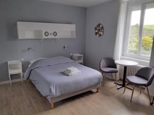 坡隆维茨普尔扎伊瑞莱斯特雷费恩特酒店的一间卧室配有一张床、两把椅子和一张桌子