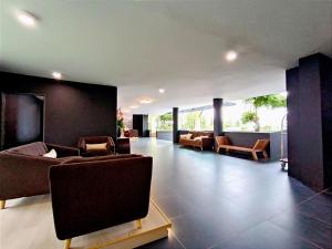 峇六拜Raia Inn Penang的带沙发和椅子的大客厅