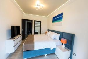 马马亚White Tower Mamaia Apartament Privat 503的一间卧室配有一张大床和电视