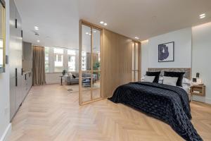 伦敦Covent Garden Piazza by Stayo的一间卧室设有一张床和一间客厅。