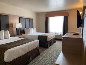 劳埃德明斯特Gold Circle Inn的酒店客房设有两张床和电视。