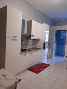 弗洛里迪亚La casa di tutti的厨房配有白色橱柜和白色冰箱。