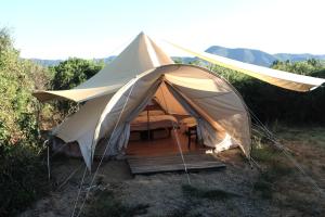 圣维托ecoVita agri-glamping的田野上带桌椅的帐篷