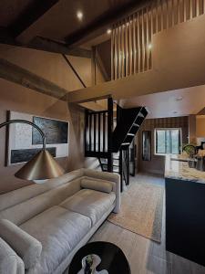 拉姆斯博滕Apartments for two in Brand New Luxury Rural Farmhouse Escape的带沙发和楼梯的客厅