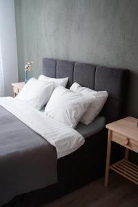 塔尔西Apartaments Nr.33 (Viesu Nr.3)的一张带白色床单和枕头的床