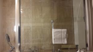 加蒂诺丽思汽车旅馆的带淋浴和白色毛巾的浴室
