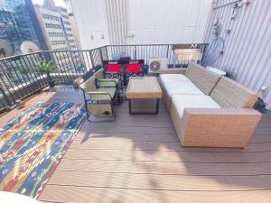 东京commun ryogoku - Vacation STAY 97137v的阳台配有沙发、桌子和地毯。