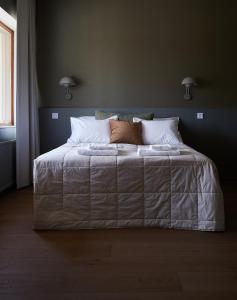 LoimaaHotelli Vihannonkulma的卧室配有一张带白色床单和枕头的大床。